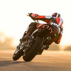 Motorcycle racer cornering at sunset