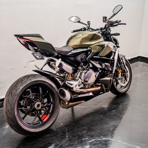 Green motorcycle parked indoors.