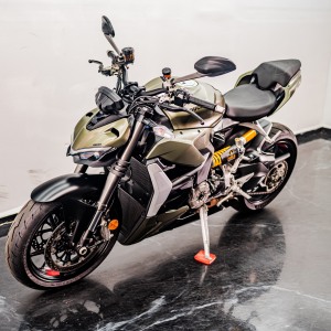 Khaki motorcycle with yellow shock absorbers.